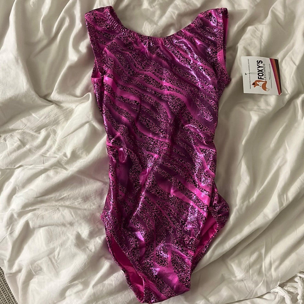 This is a pink with black, print, gymnastics leotard